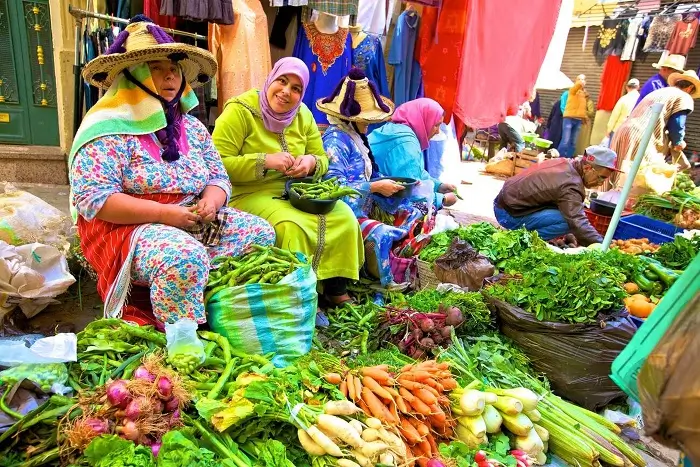 tour of tangier local market with stalls of spices, fresh produce, and traditional crafts