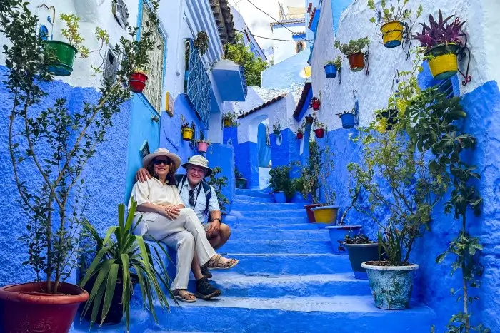 Travelers enjoying the blue alleyways of Chefchaouen on a 10 day trip to Morocco