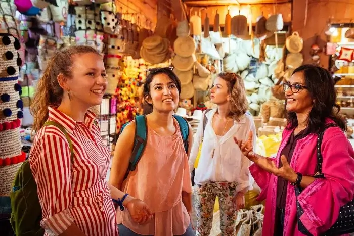 Tourists shopping in a traditional Moroccan souk during a city tour of Marrakech medina on a Casablanca to Marrakech tour