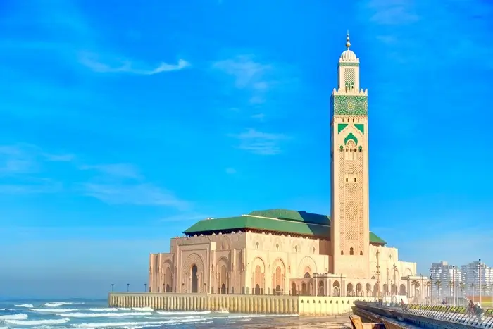 The magnificent Hassan II Mosque rising above the Atlantic Ocean in Casablanca on a luxury Morocco honeymoon