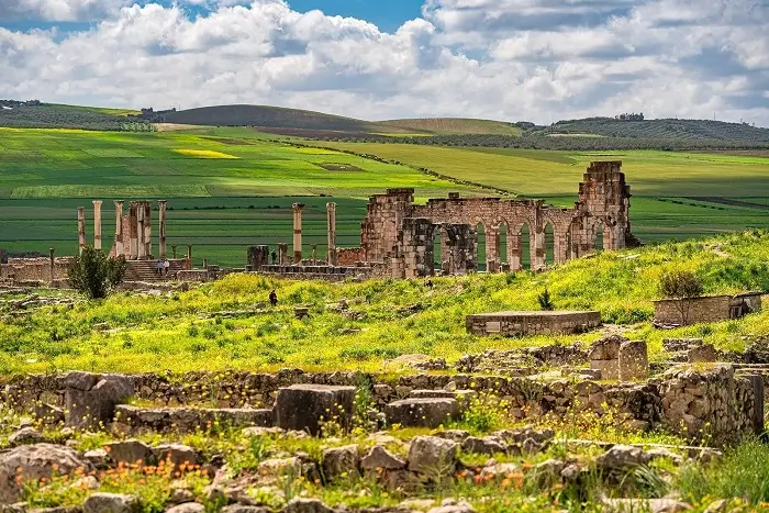 Exploring the ancient Roman ruins of Volubilis UNESCO World Heritage Site on a Morocco honeymoon tour