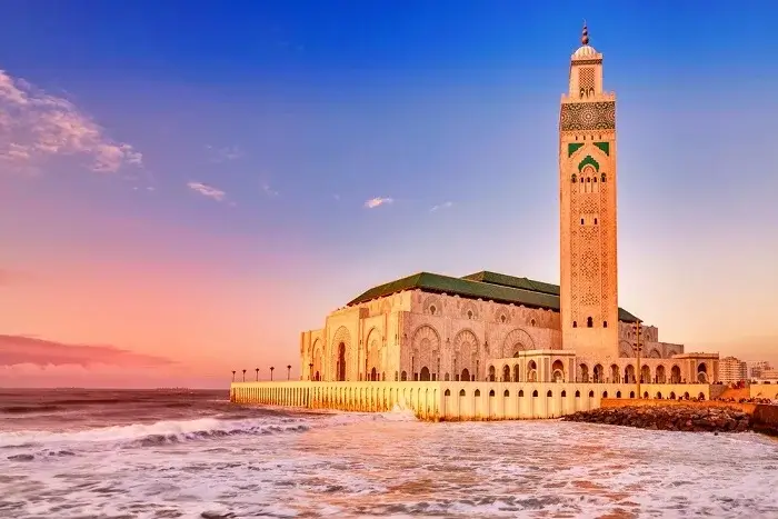 Hassan II Mosque at sunset overlooking the Atlantic Ocean in Casablanca on a 14 day Morocco itinerary