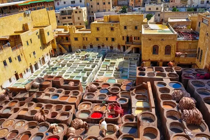 Aerial view of the colorful dye vats and leather workers at the ancient Chouara Tannery in the medina of Fes on a 14 days Morocco itinerary