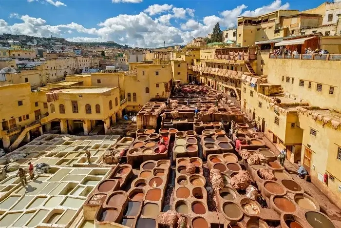 Traditional leather dyeing vats at Chouara Tannery in Fes during a 15 Day Grand Tour of Morocco